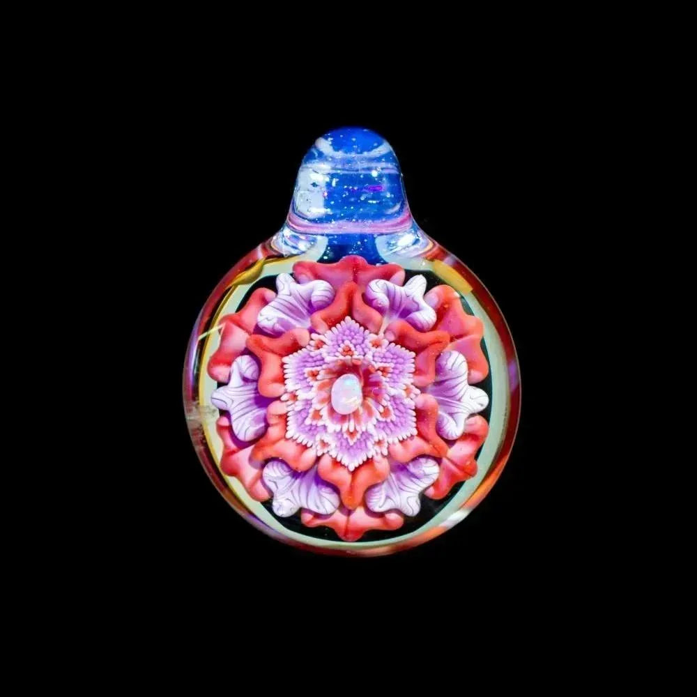 Handcrafted glass flower pendant with vibrant pink, purple, and opal details on black background.