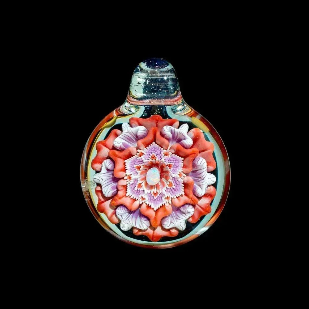 Hand-blown glass flower pendant with pink, coral, and purple opal dot details on black background.