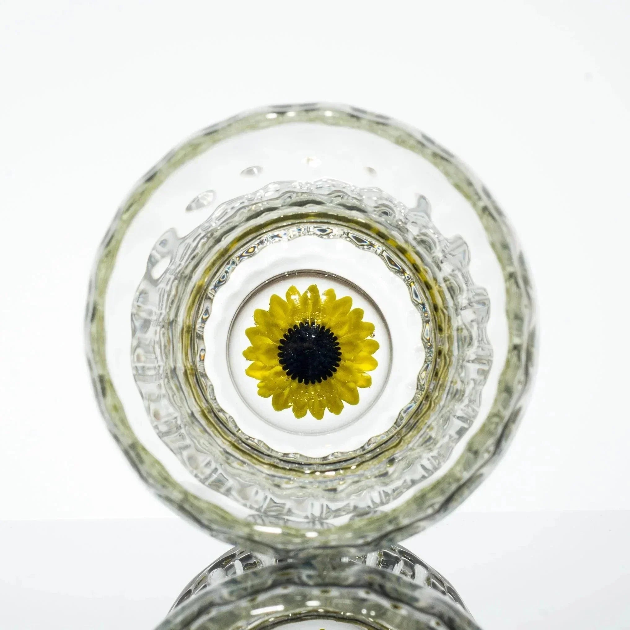 Clear glass pipe with embedded yellow flower design, showcasing intricate craftsmanship and vibrant detail.