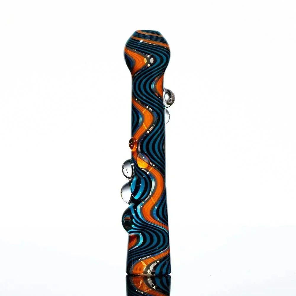 Hand-blown glass chillum with blue, black, and orange wig wag swirl design and clear marbles.
