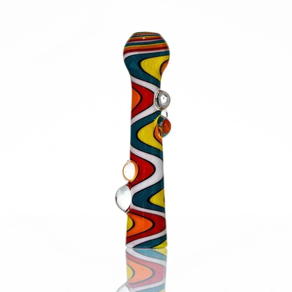 Colorful glass hand pipe with wavy wig wag pattern and decorative glass marbles