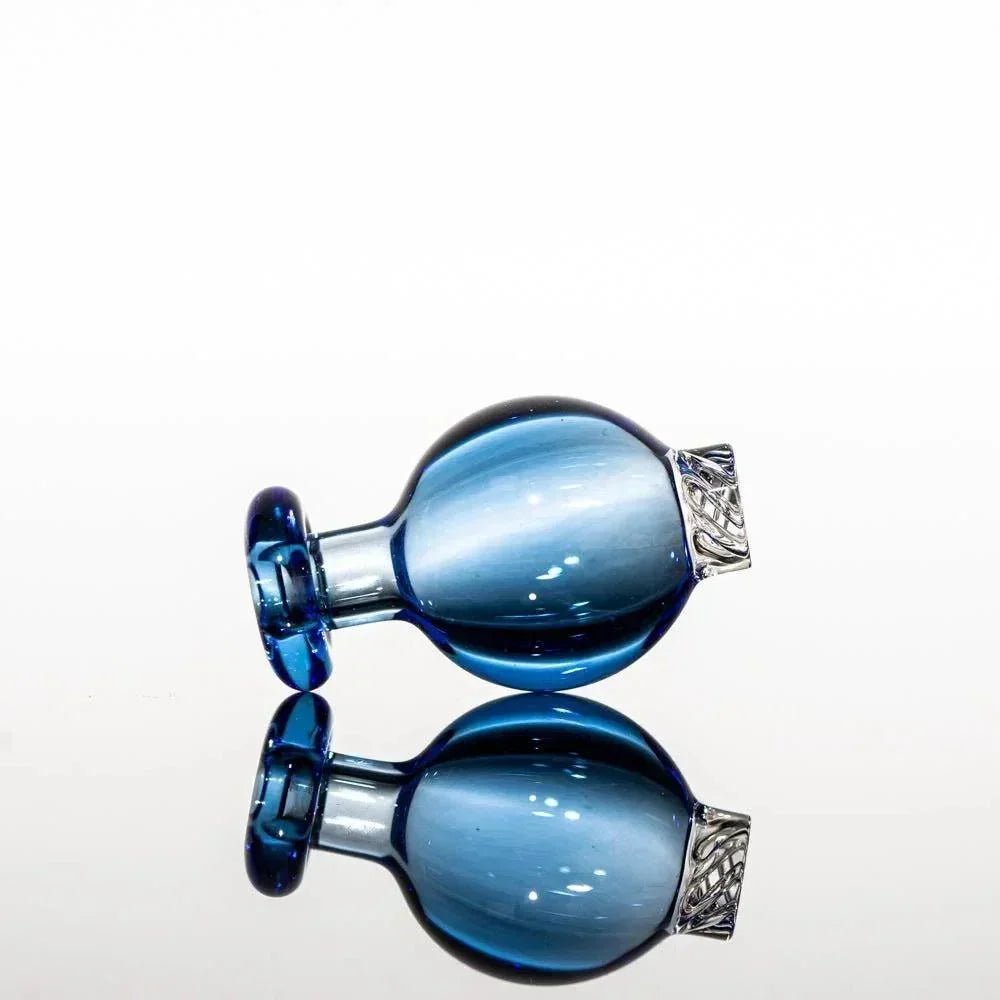 Blue glass pipe with silver filigree accent, reflective surface