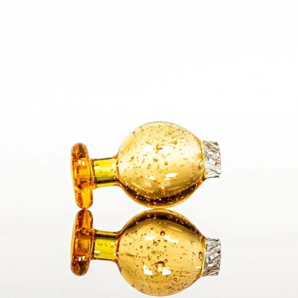 Amber glass pipe with bubble texture and silver accents, reflective surface