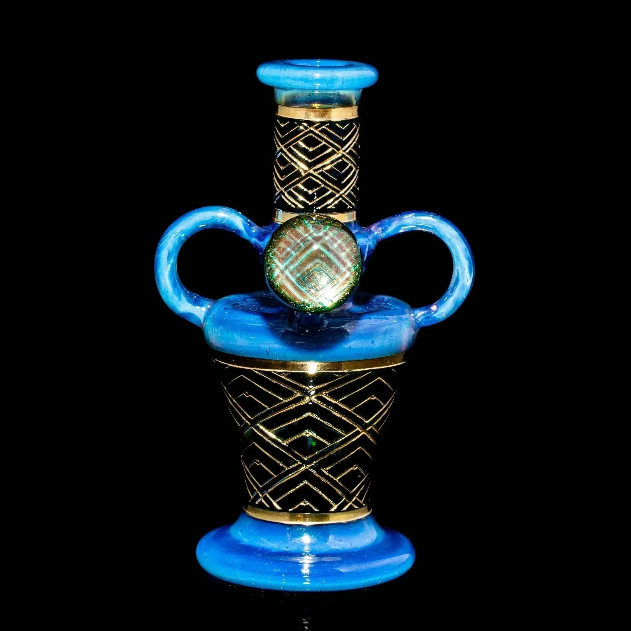 Blue art deco glass vessel with gold geometric patterns and dual handles on black background.