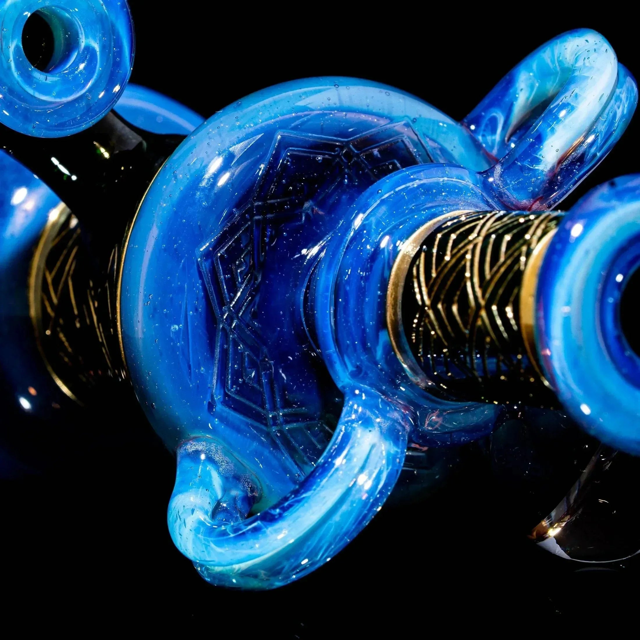 Blue art deco glass vessel with intricate geometric engravings and gold accents