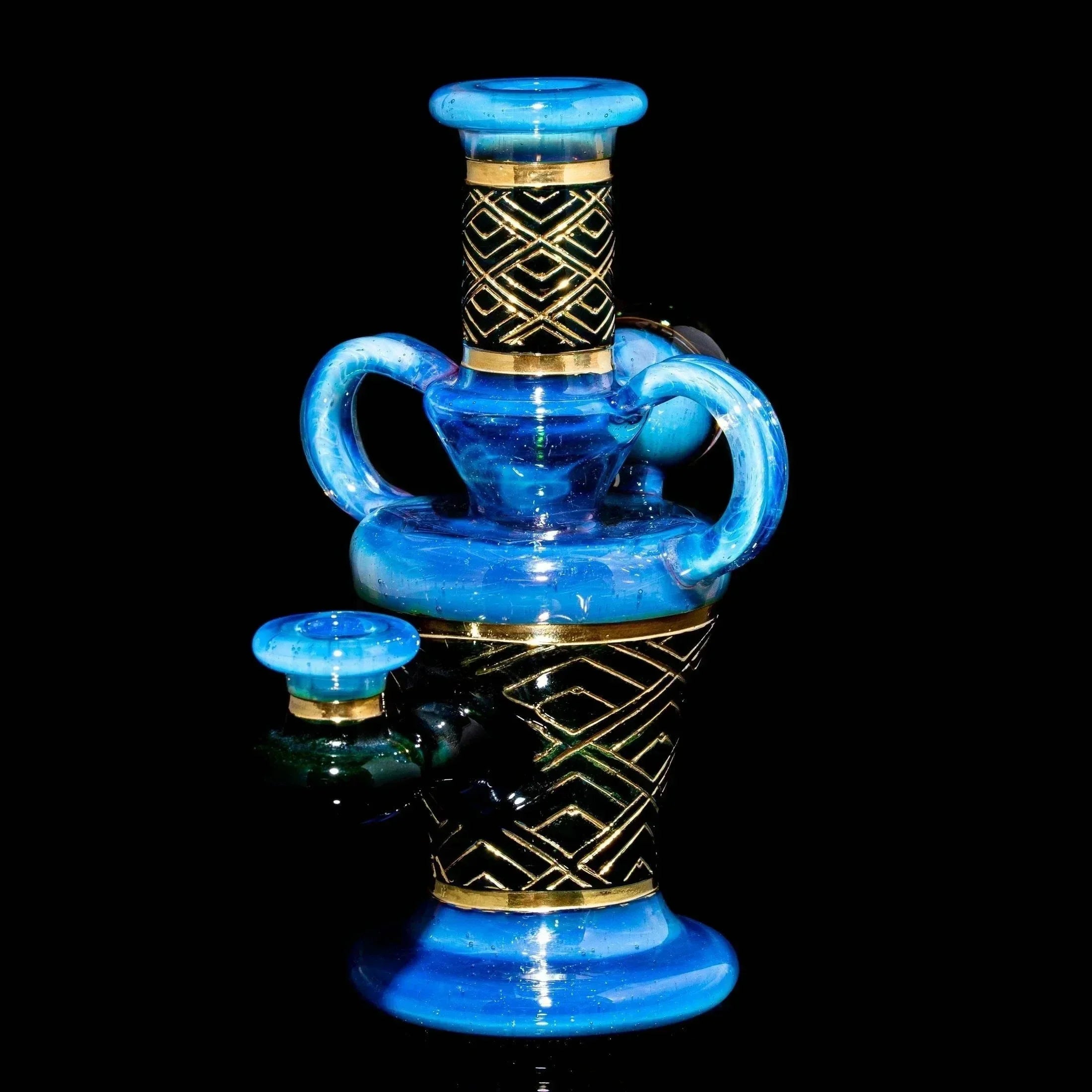 Blue art deco glass water pipe with gold geometric accents on a black background