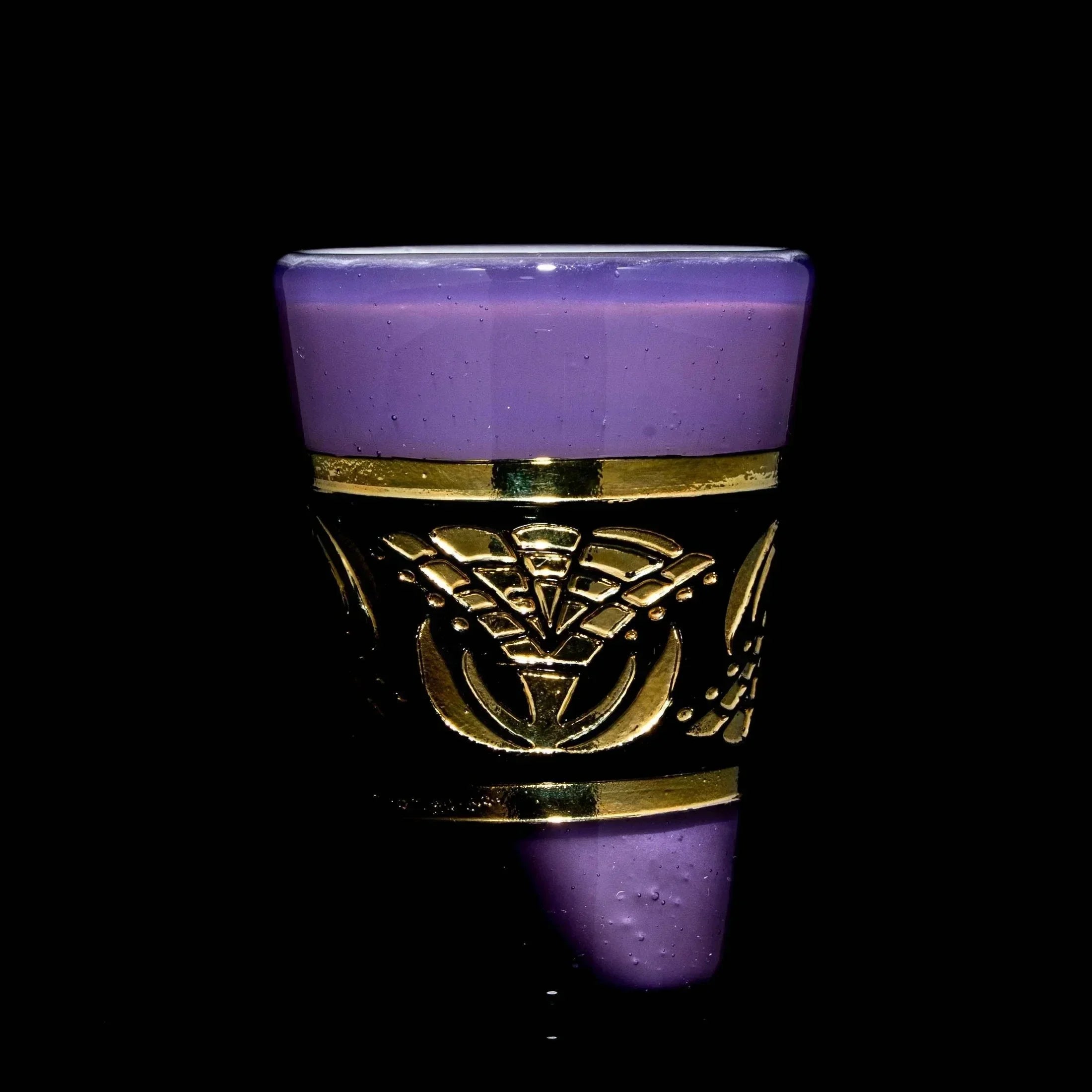 Purple satin shot glass with gold decorative band, black background, collectible glassware