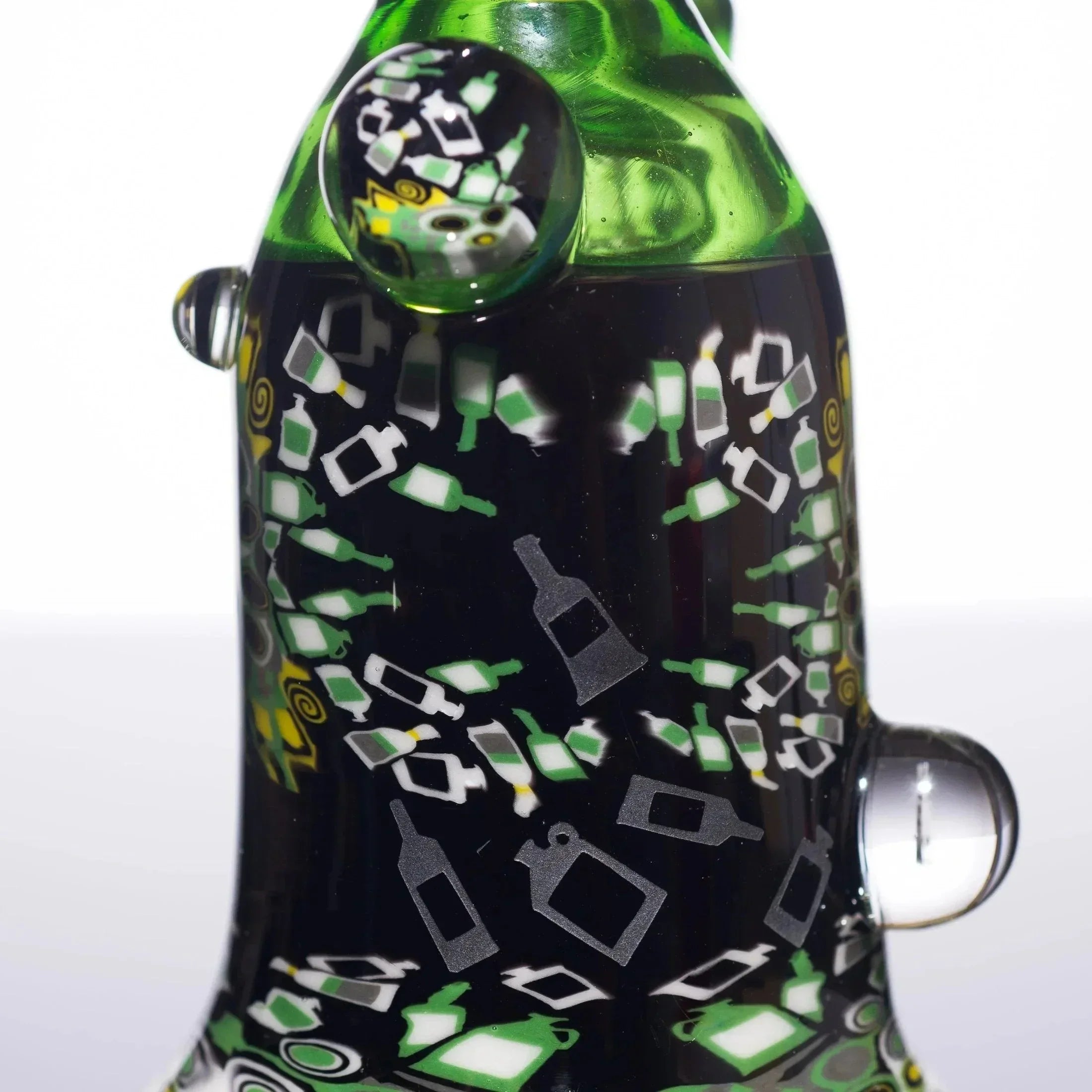 Green and black heady glass bong with bottle patterns and swirls, featuring intricate designs and colorful accents.