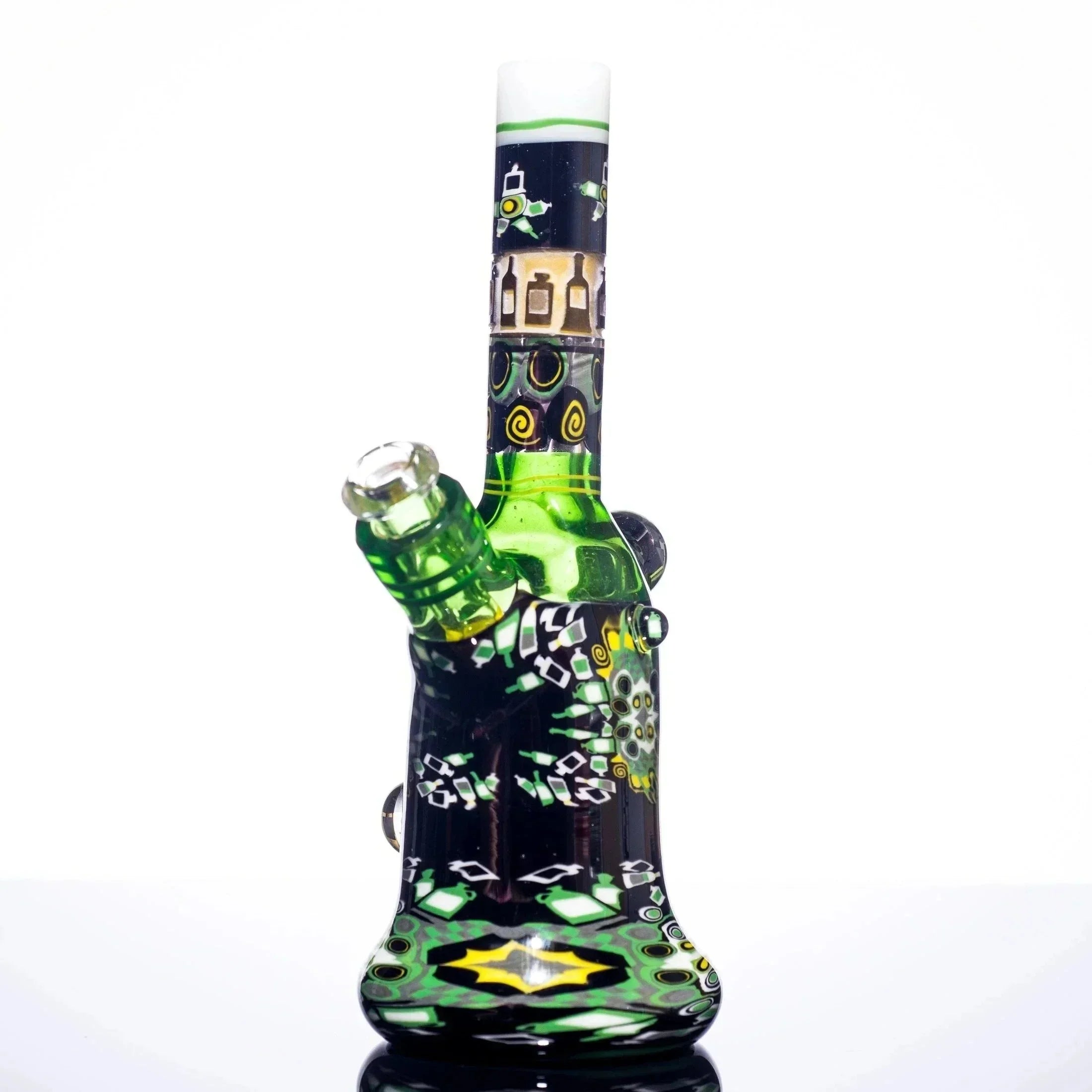 Green and black patterned glass bong with intricate designs and yellow accents, studio shot
