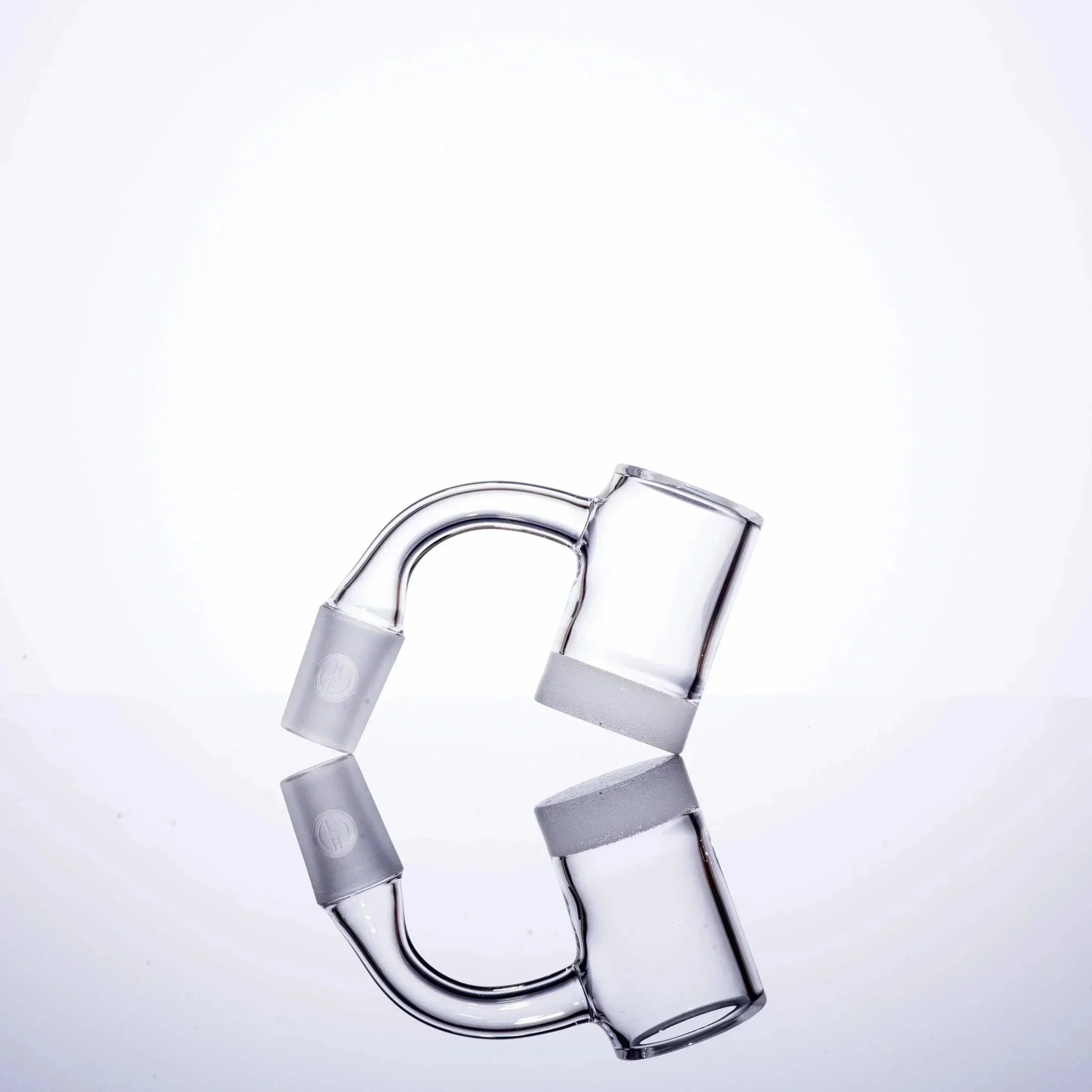 Clear glass U-shaped pipe with frosted joints, minimalist studio shot
