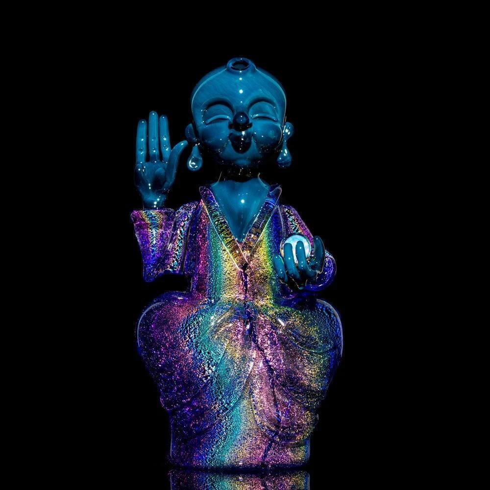 Colorful dichroic glass Buddha statue with shimmering rainbow robe on black background