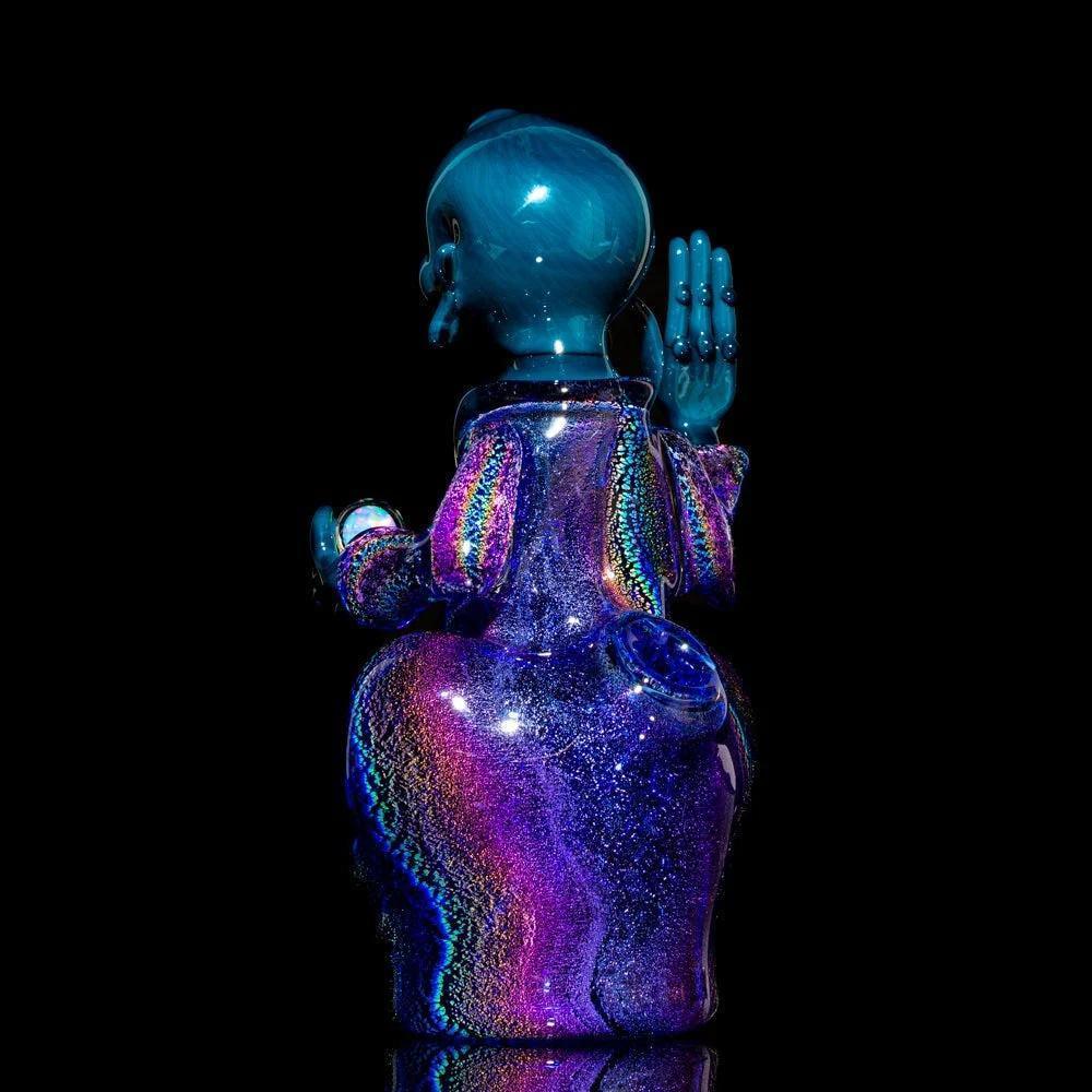 Colorful dichroic glass Buddha sculpture with shimmering rainbow effect on black background
