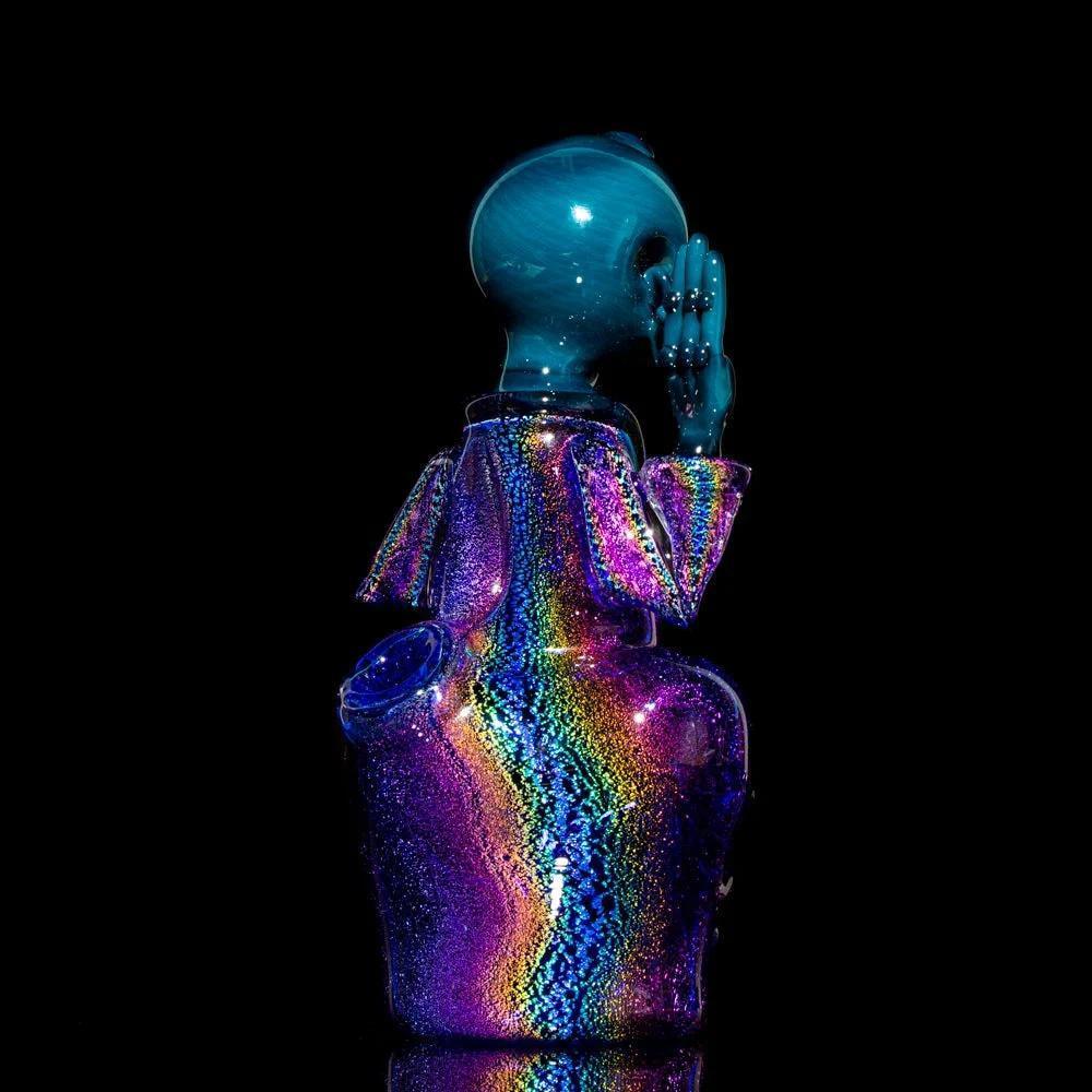 Colorful iridescent glass Buddha-style art pipe with rainbow dichroic finish on black background.