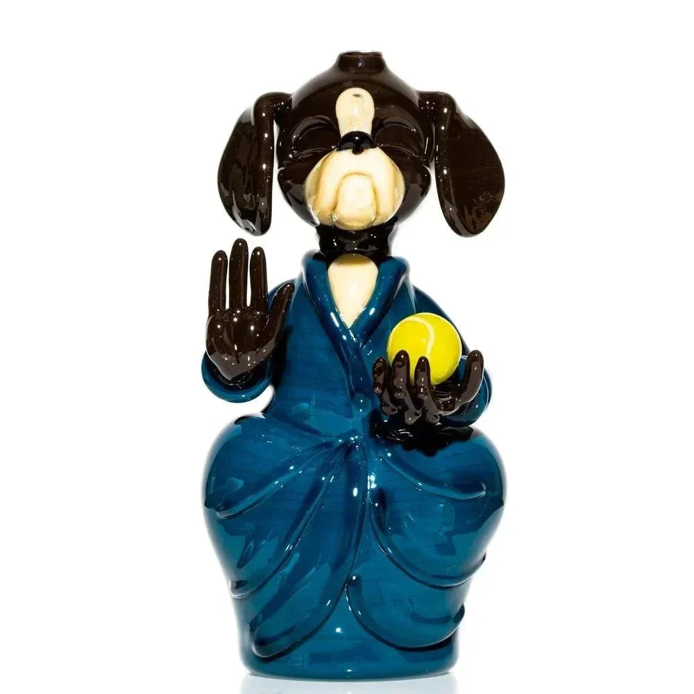 Handcrafted glass sculpture of a meditating dog in a blue robe holding a yellow ball.