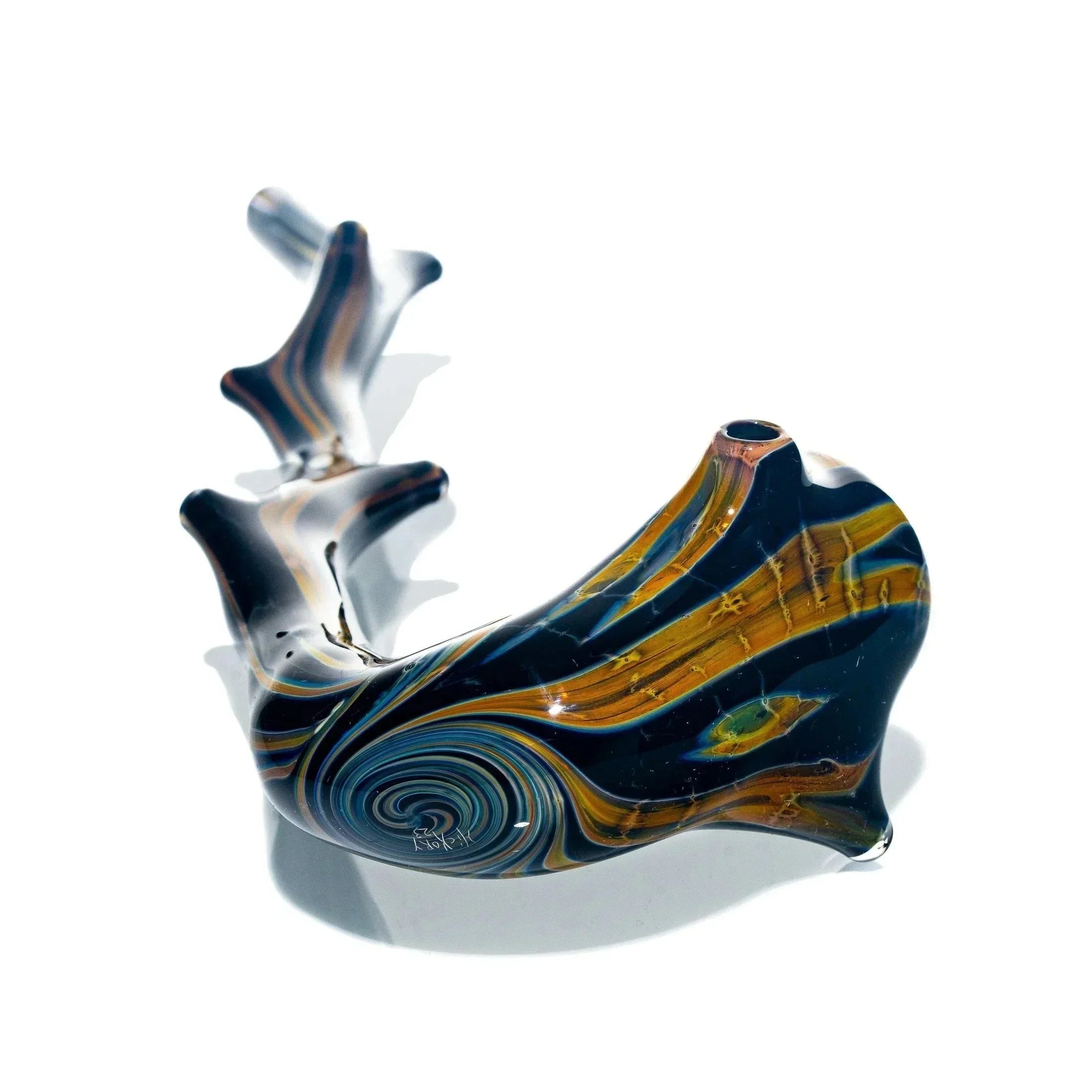 Handblown glass pipe with brown and blue swirl design on white background