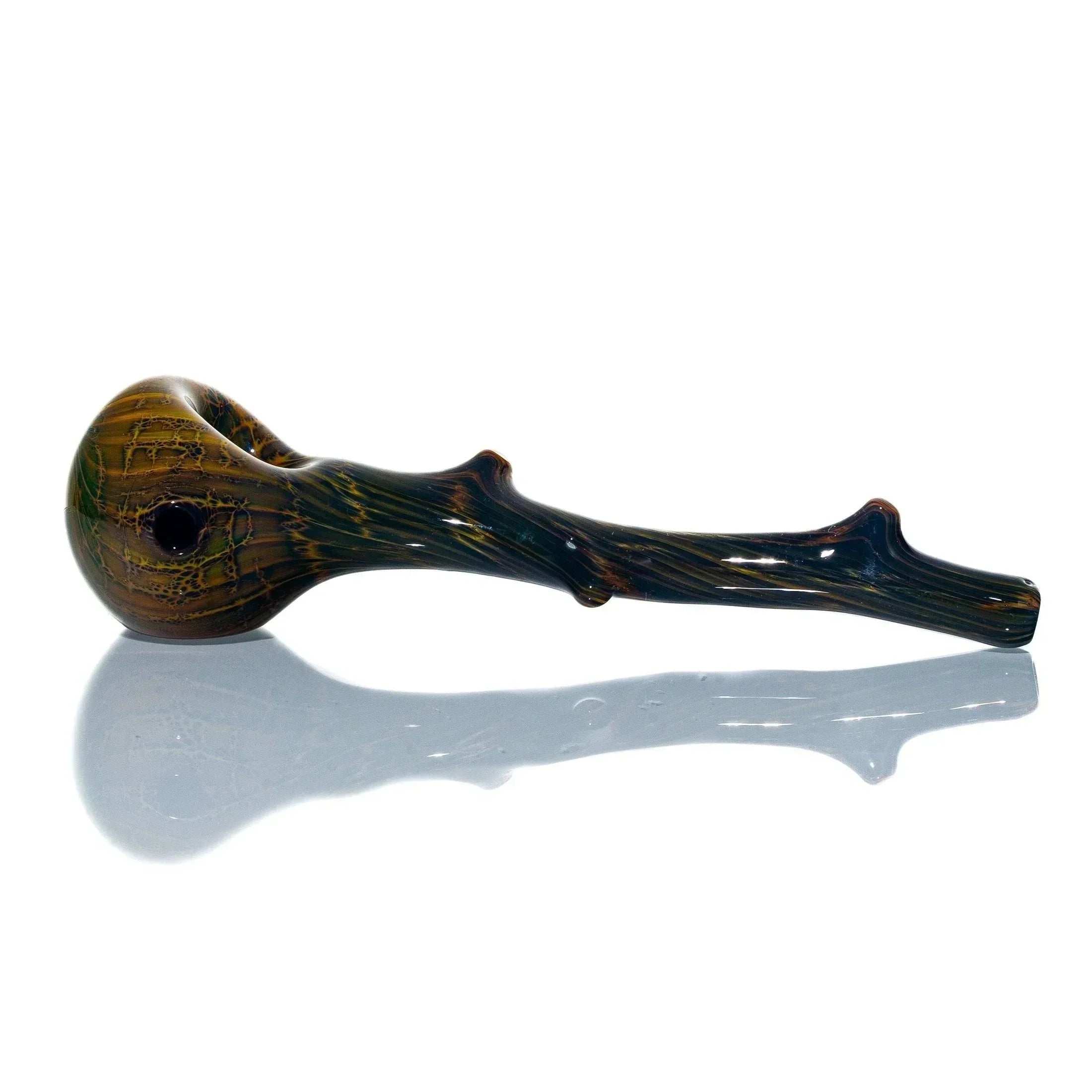 Glass hand pipe shaped like a wooden branch with textured brown and green finish