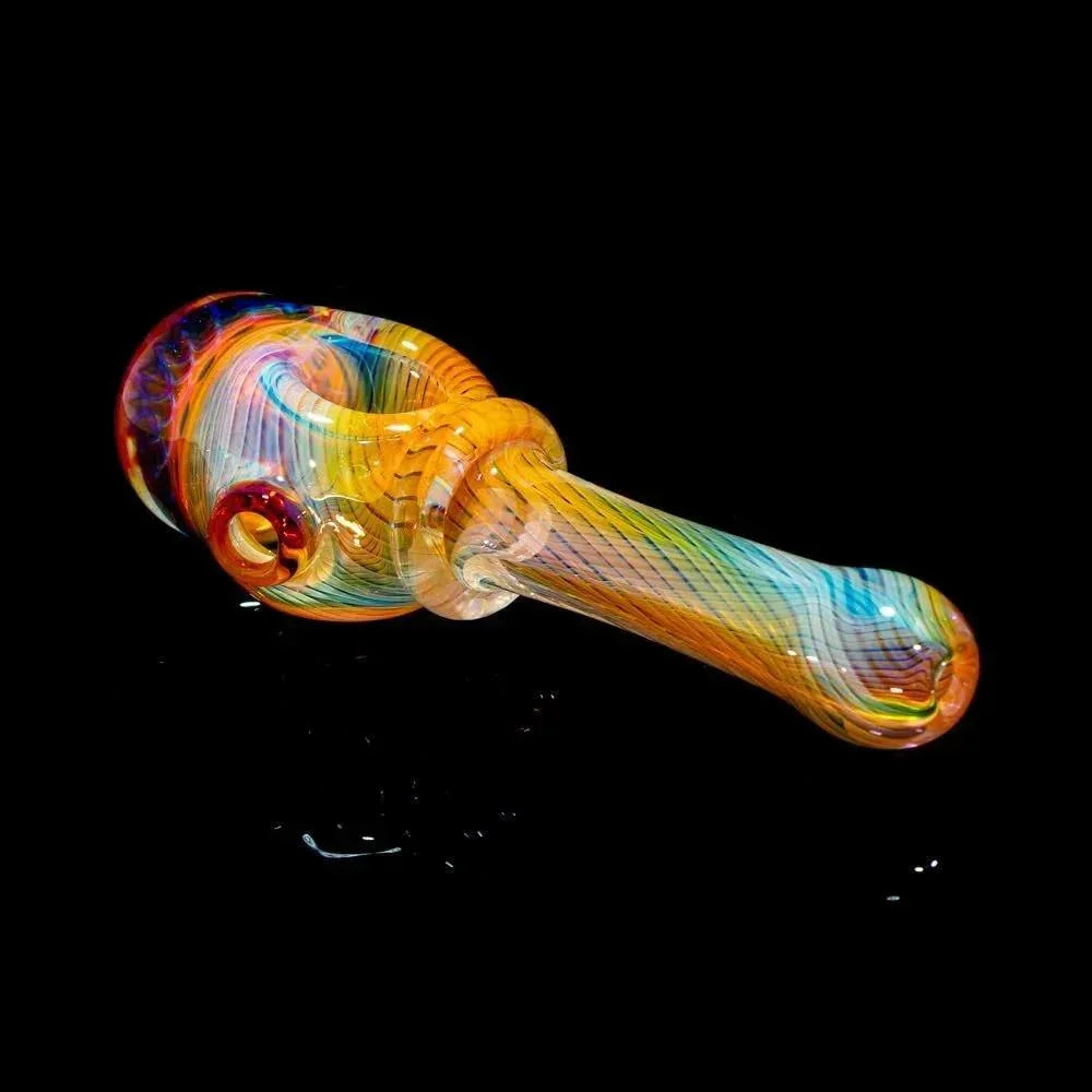 Colorful honeycomb linework glass hand pipe with vibrant swirls on a black background.