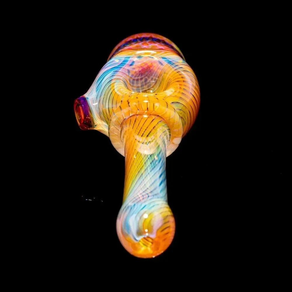 Colorful honeycomb glass hand pipe with intricate linework on a black background