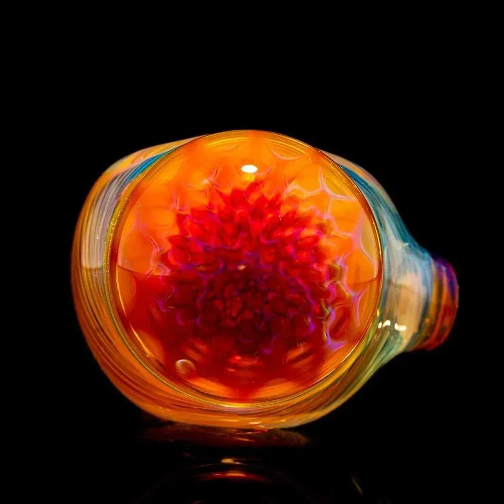 Colorful glass spoon pipe with vibrant honeycomb pattern and intricate red linework design