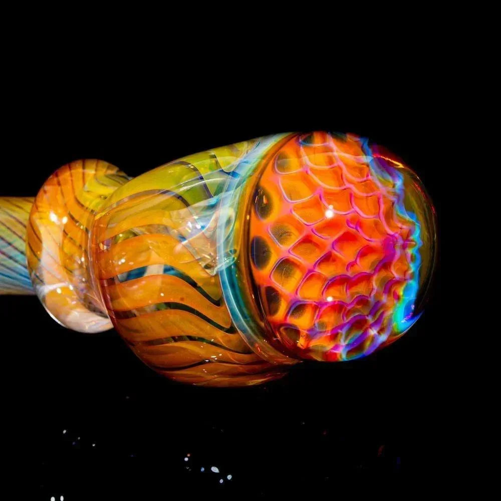 Colorful honeycomb glass spoon pipe with vibrant linework on black background