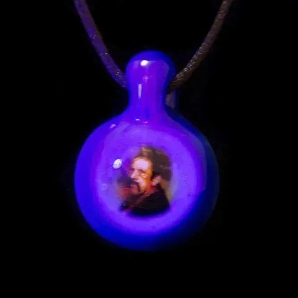 Glowing purple glass pendant with embedded portrait, heady glass art for smoke shop accessories