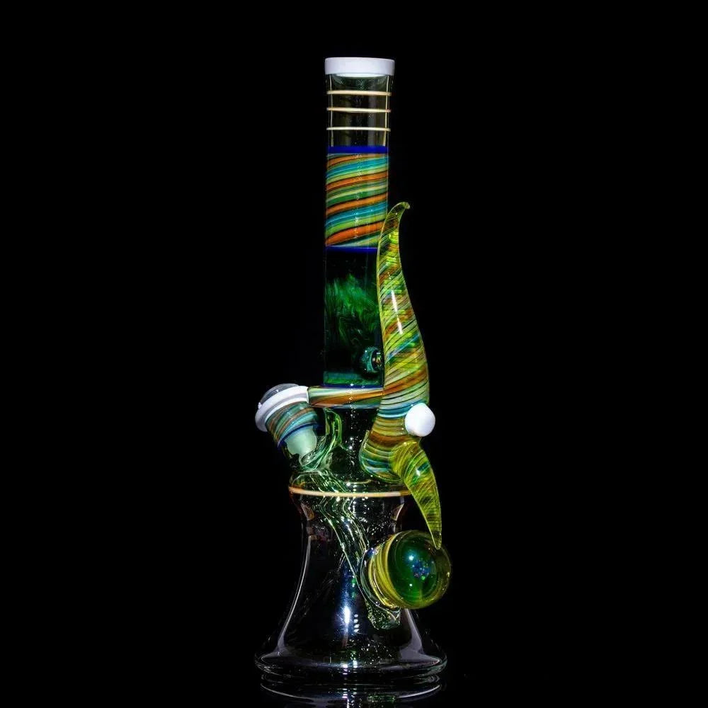 Colorful heady glass bong with swirls and green accents, studio shot on black background