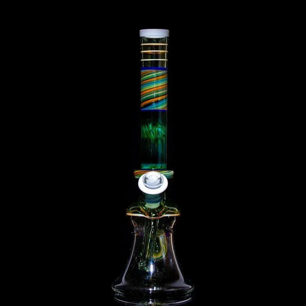 Colorful heady glass bong with swirls and gold accents, studio shot on black background