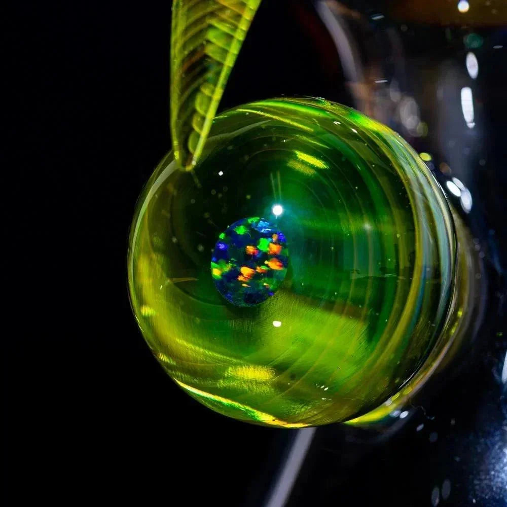 Vibrant green glass pipe with opal frit, showcasing heady glass artistry and colorful swirls.