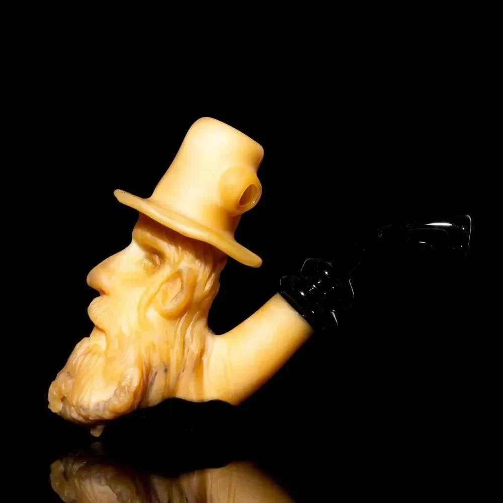 Handcrafted glass pipe shaped like an old man's bearded face with a hat, displayed on black background.
