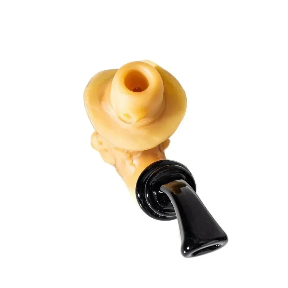 Hand-blown glass pipe with tan bowl and black mouthpiece on white background