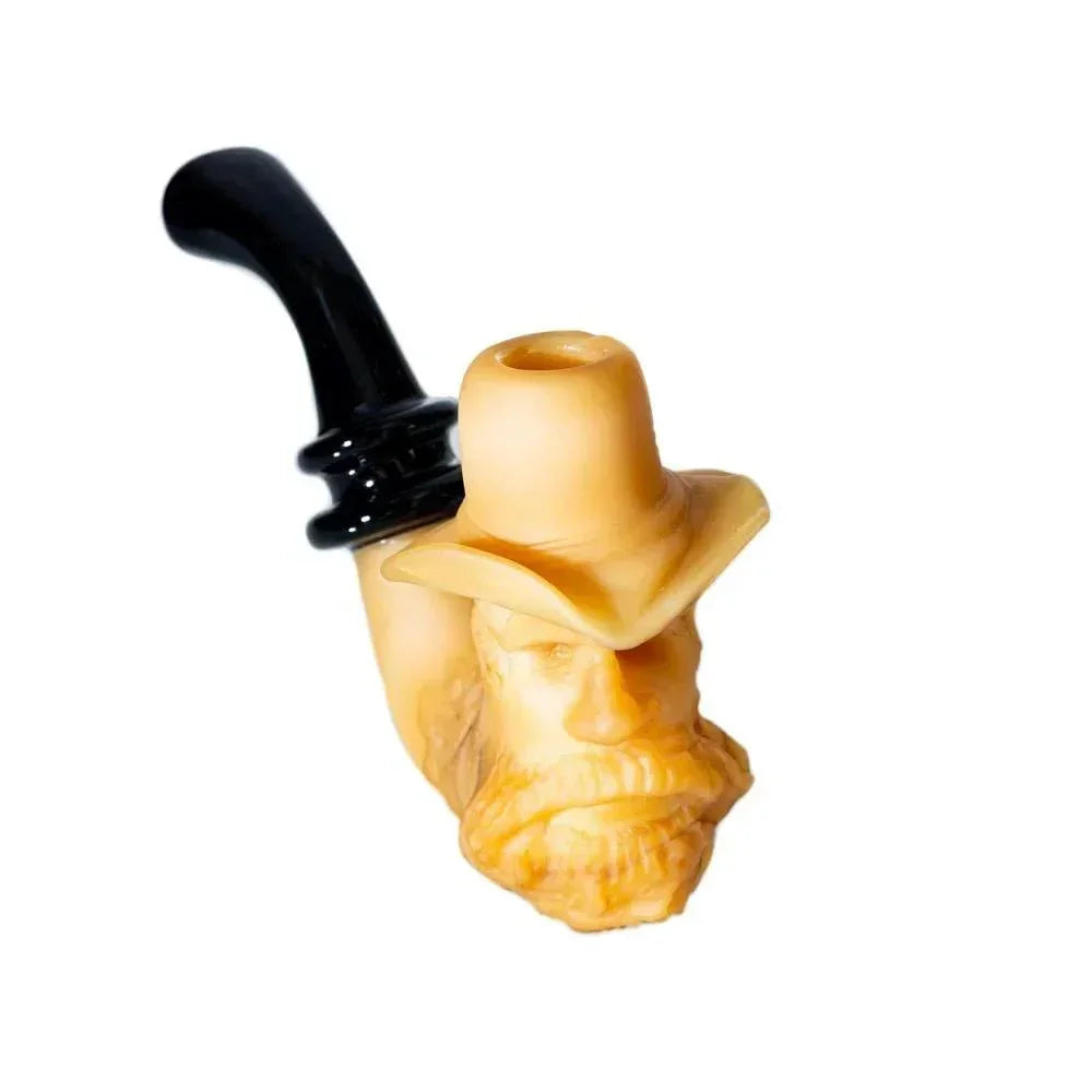 Handcrafted glass pipe shaped like an old man's head with a hat, on white background.