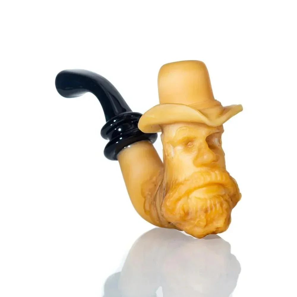 Carved tobacco pipe with old man's face wearing hat, artful handcrafted smoking accessory