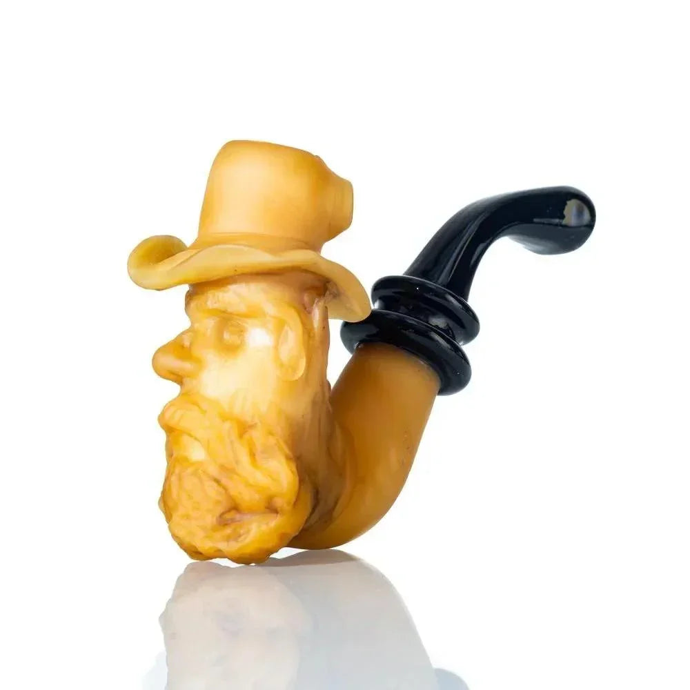 Handcrafted glass pipe shaped like an old man's head with a hat, black mouthpiece
