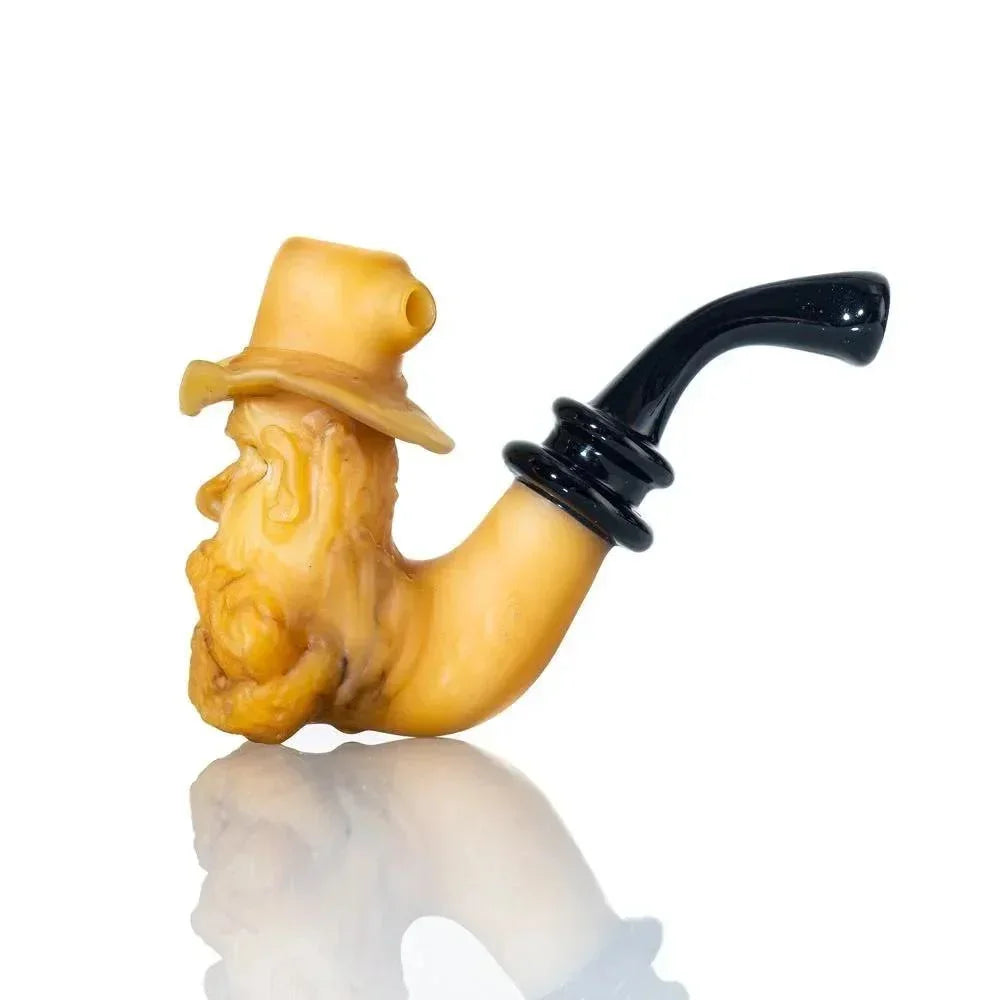 Glass hand pipe shaped like an old man's face with a hat and black mouthpiece