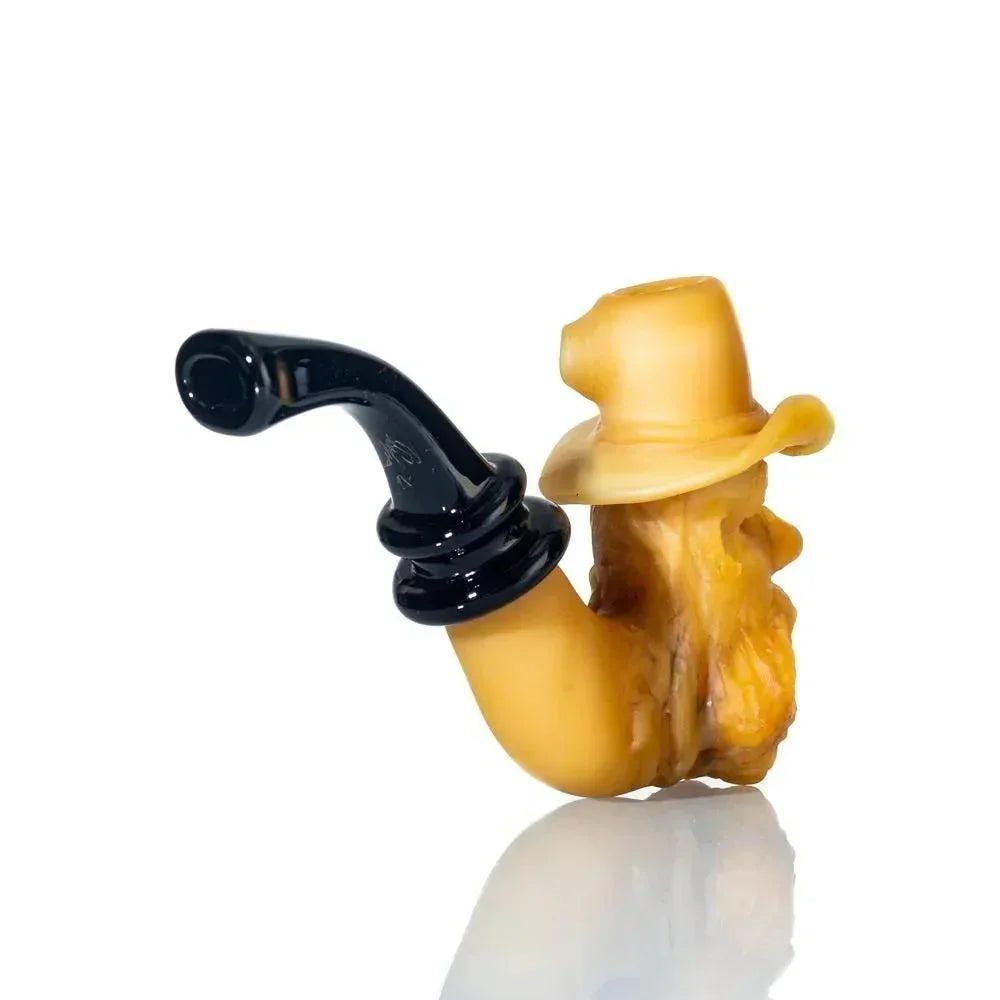 Hand-blown glass novelty pipe shaped like an old man's face with a hat, on white background.