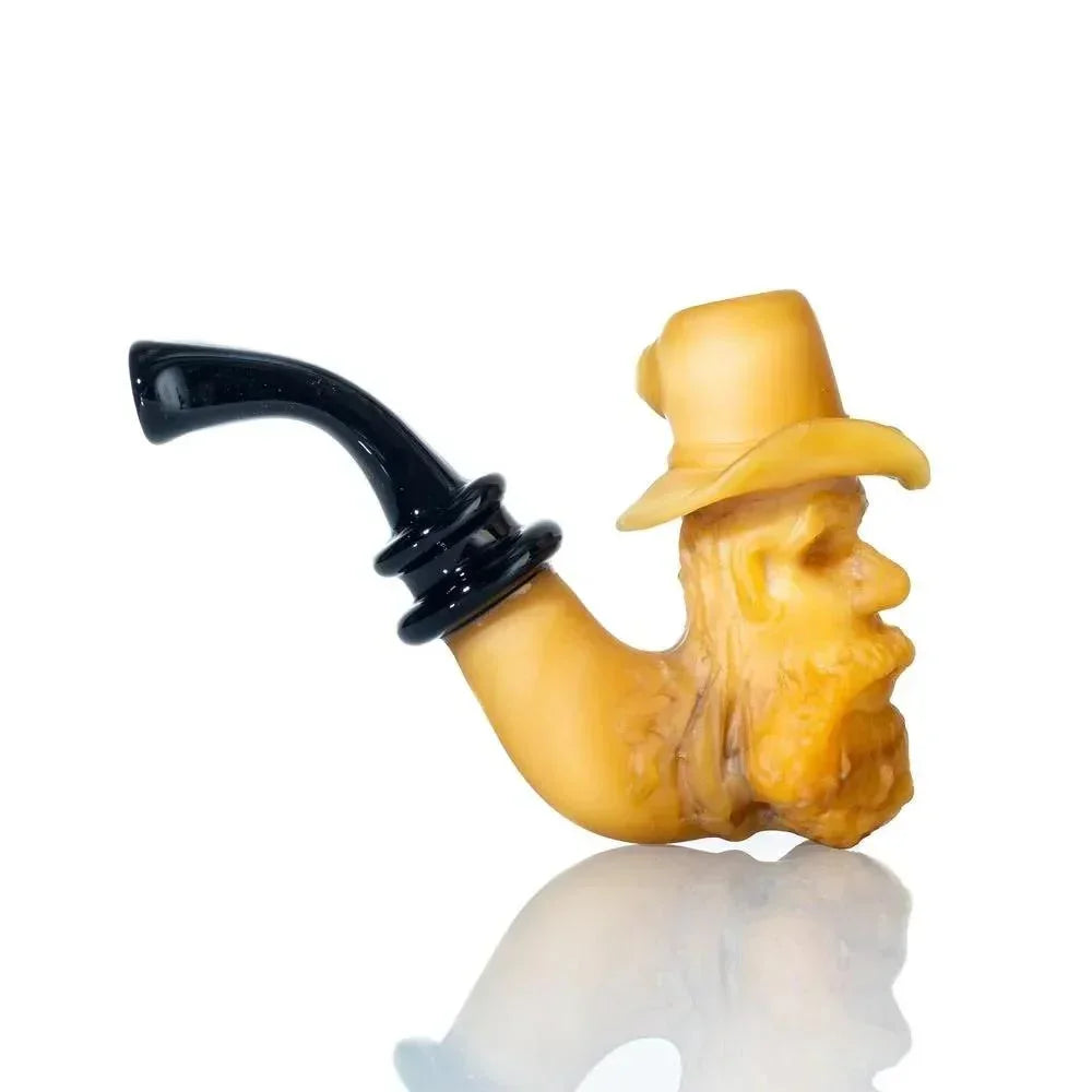 Handcrafted glass pipe shaped like an old man's head with hat, curved black mouthpiece