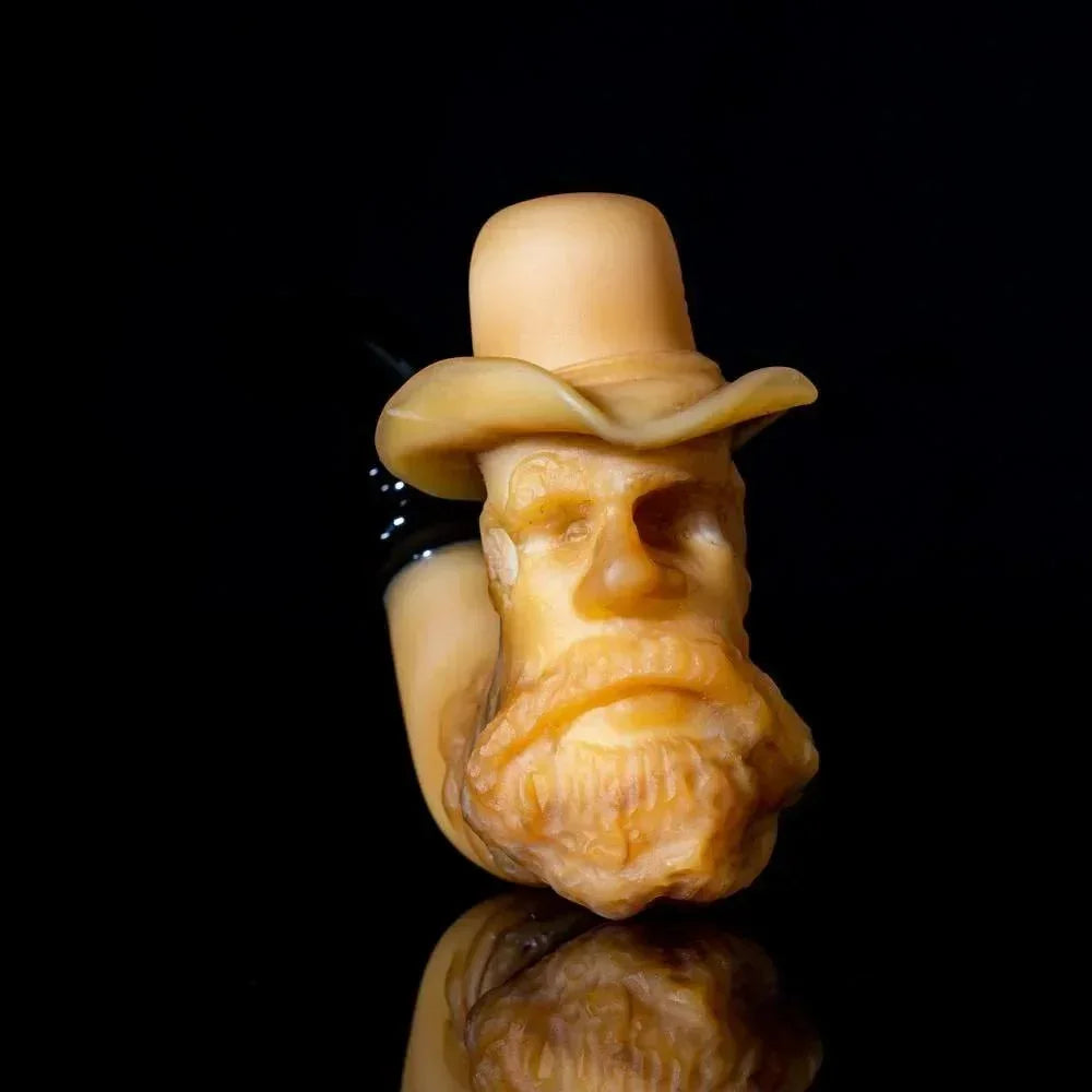 Handcrafted glass pipe shaped like an old man's bearded face with a hat on black background
