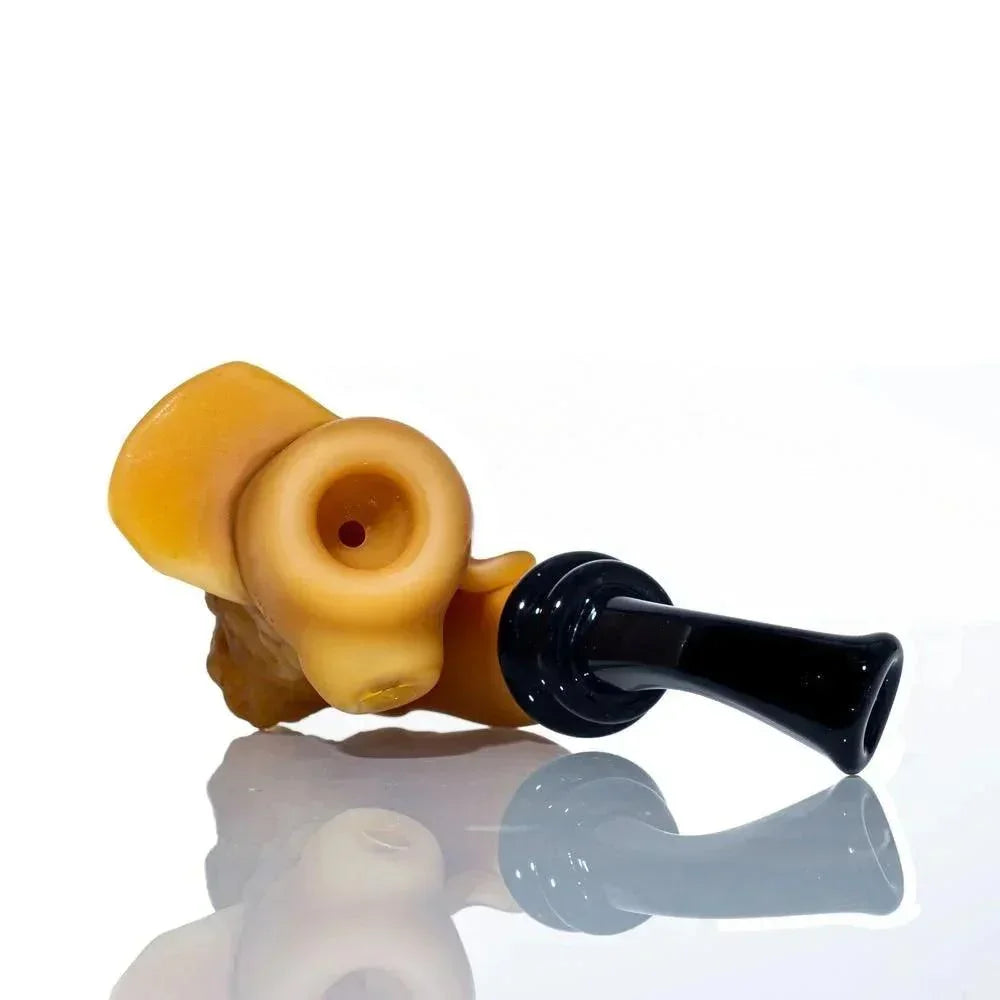 Handcrafted glass smoking pipe with a black mouthpiece and sculpted amber bowl on white background