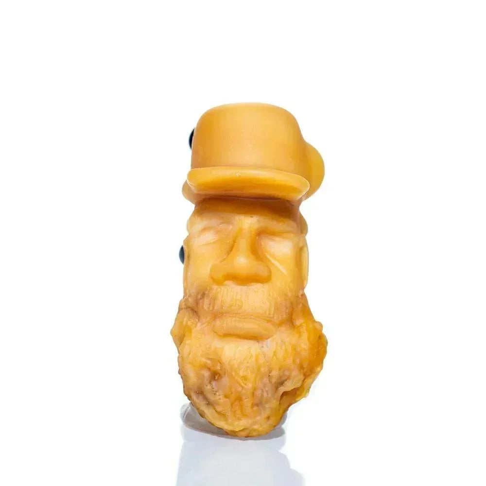 Handcrafted glass pipe shaped like an old man's bearded face wearing a hat on white background