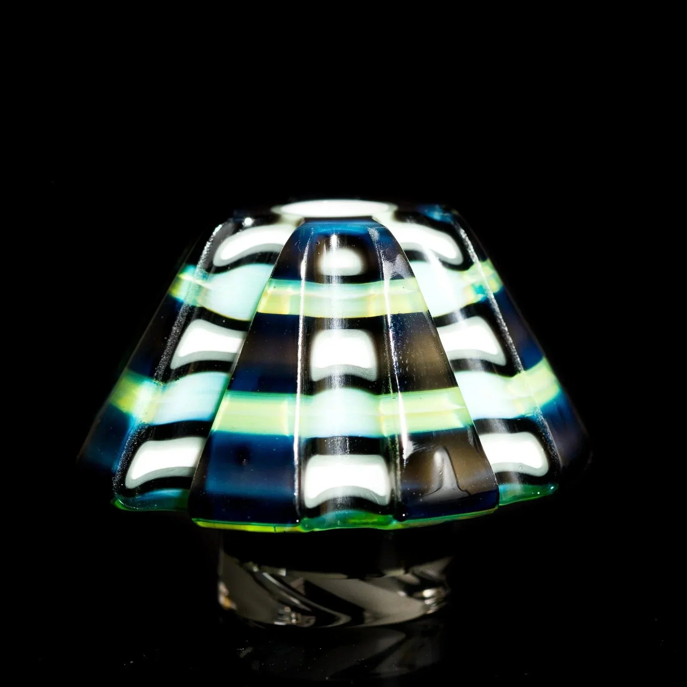 Colorful striped glass pipe bowl with blue, green, and white swirls on black background