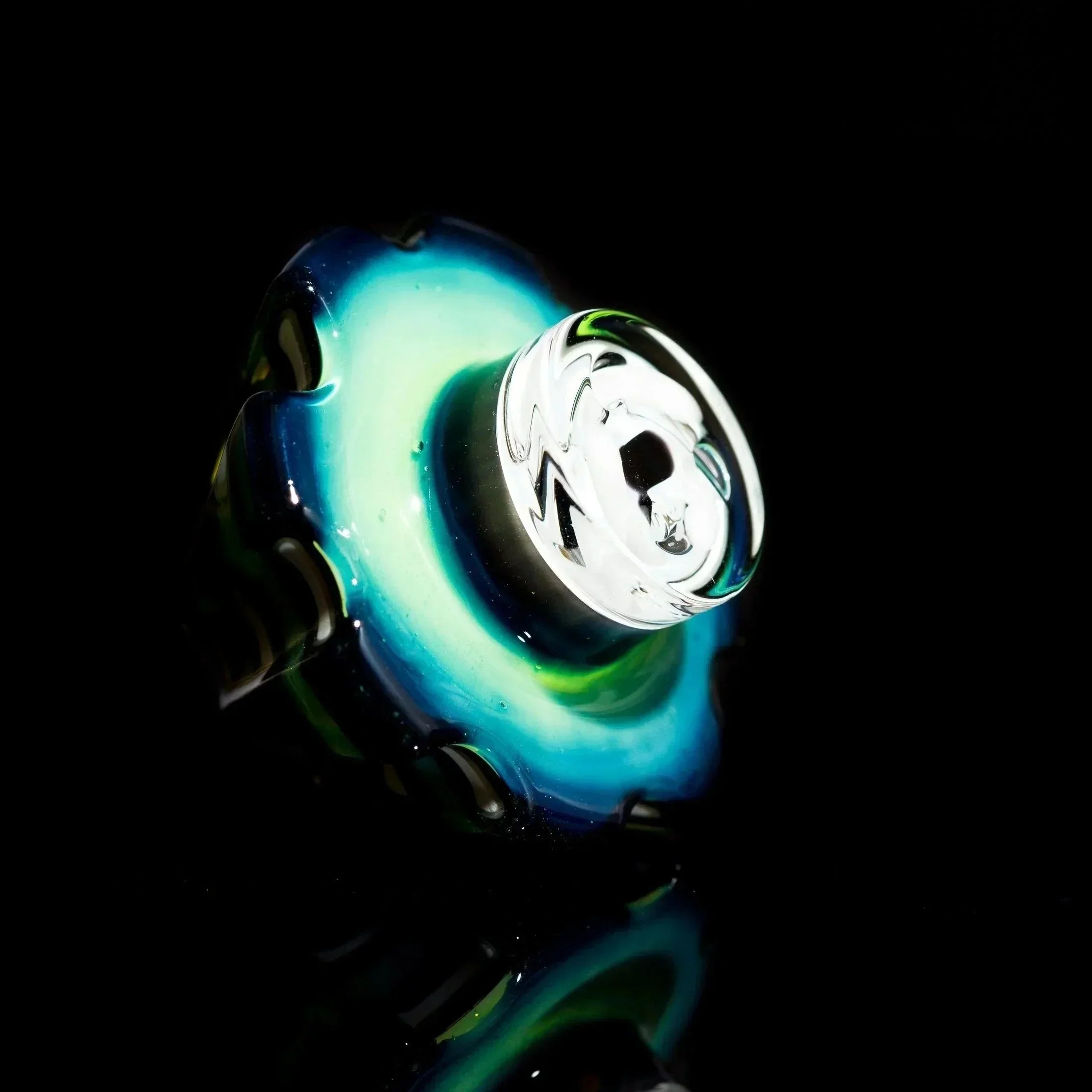 Heady glass pipe with swirling blue, green, and white colors against black background