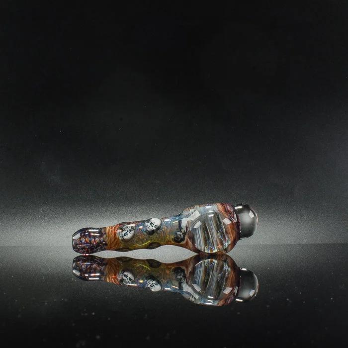 Colorful skull-patterned glass pipe with reflective surface, heady glass art for collectors