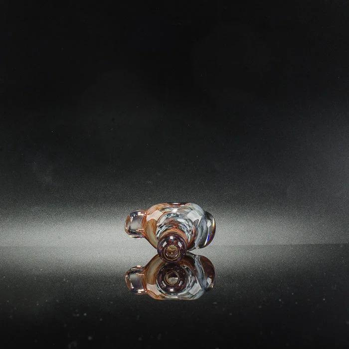 Hand-blown glass pipe with amber swirls, reflective surface, studio lighting
