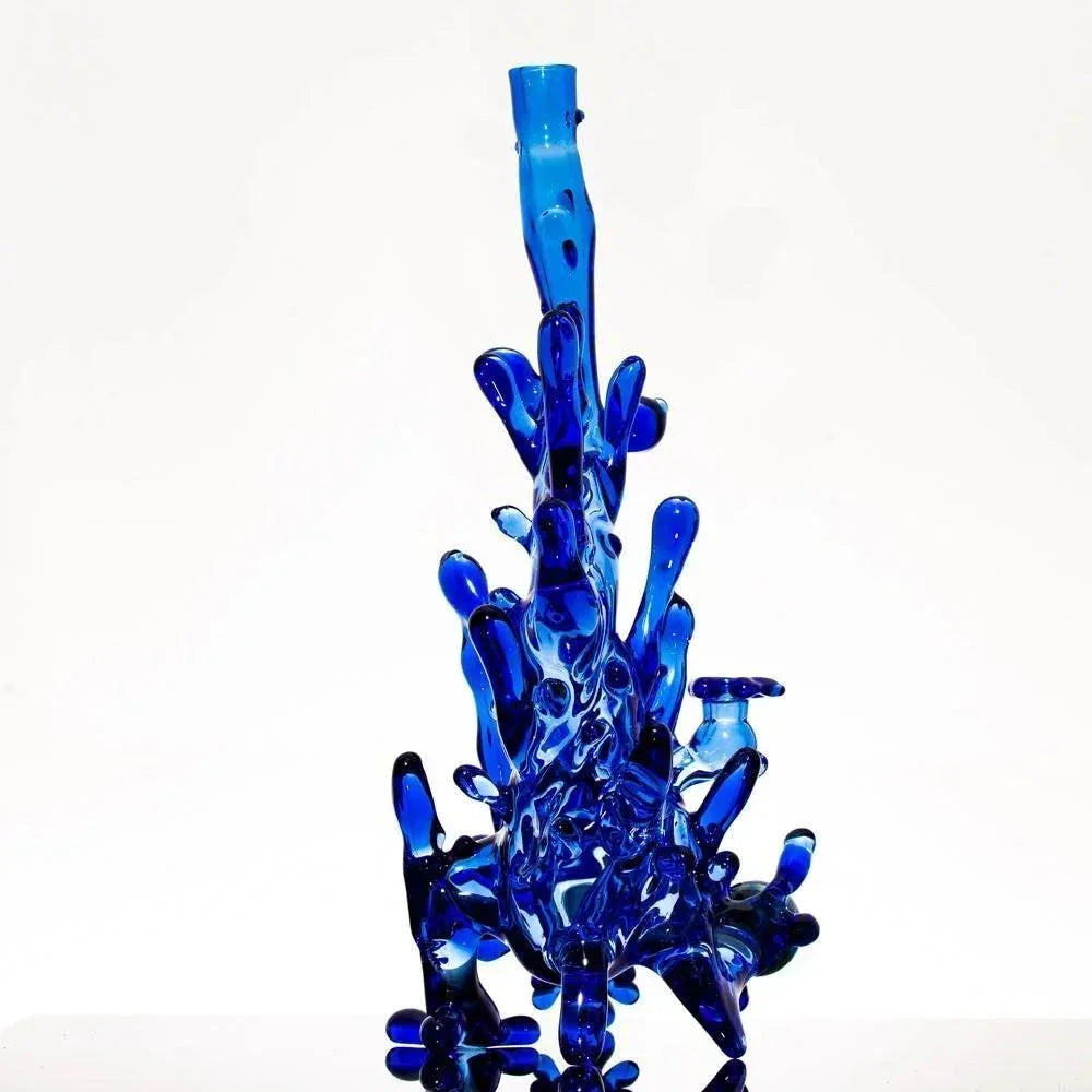 Vibrant blue heady glass bong with intricate, organic bubble design, showcasing artistic craftsmanship.