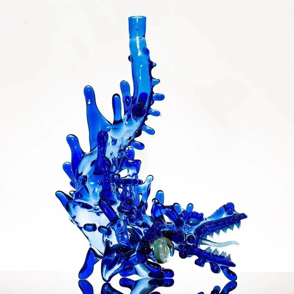 Vibrant blue heady glass dragon bong with intricate splash design and detailed scales