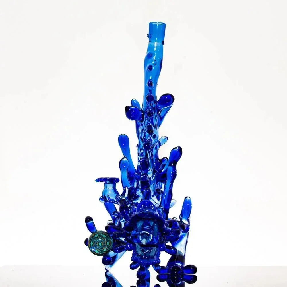 Vibrant blue heady glass bong with intricate bubble details and green accent globe