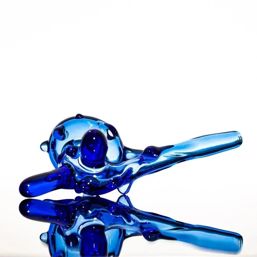 Blue heady glass pipe with intricate swirls and reflective surface, showcasing premium glass artistry