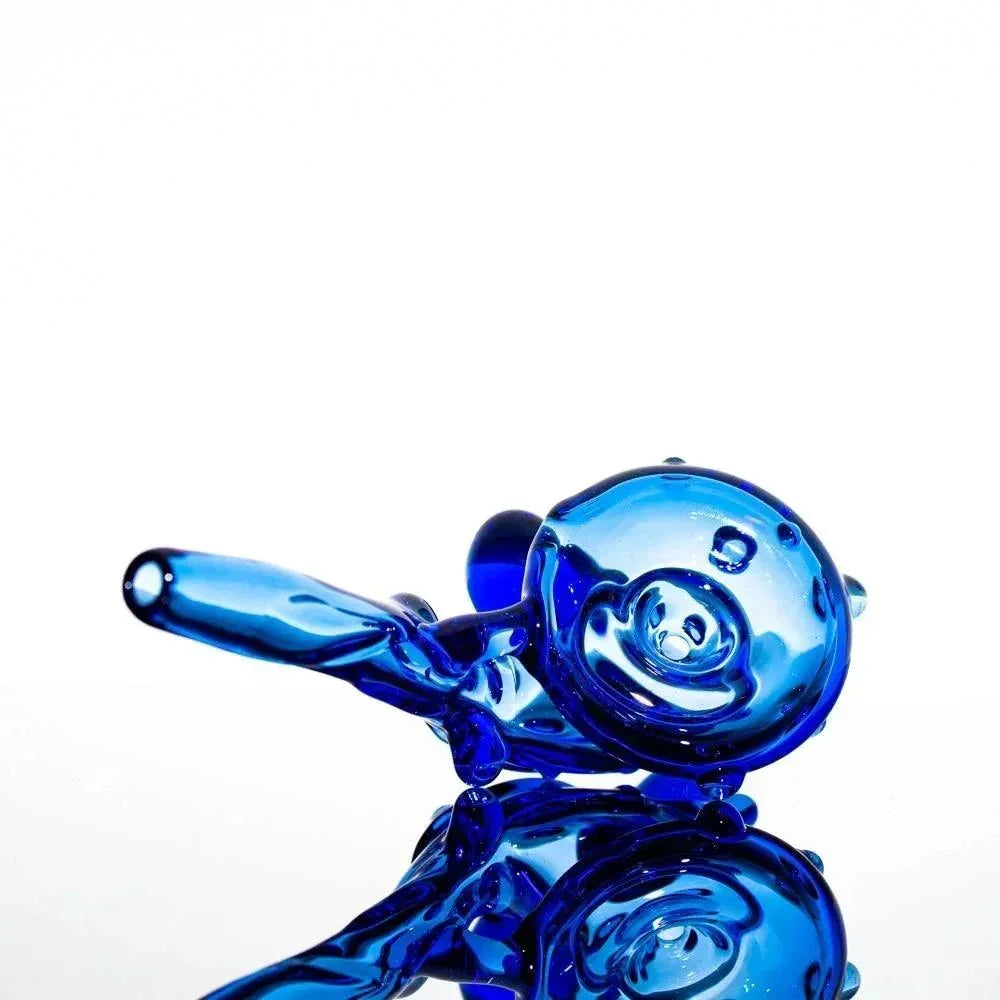 Vibrant blue glass pipe with swirling design, reflective surface, heady glass art piece