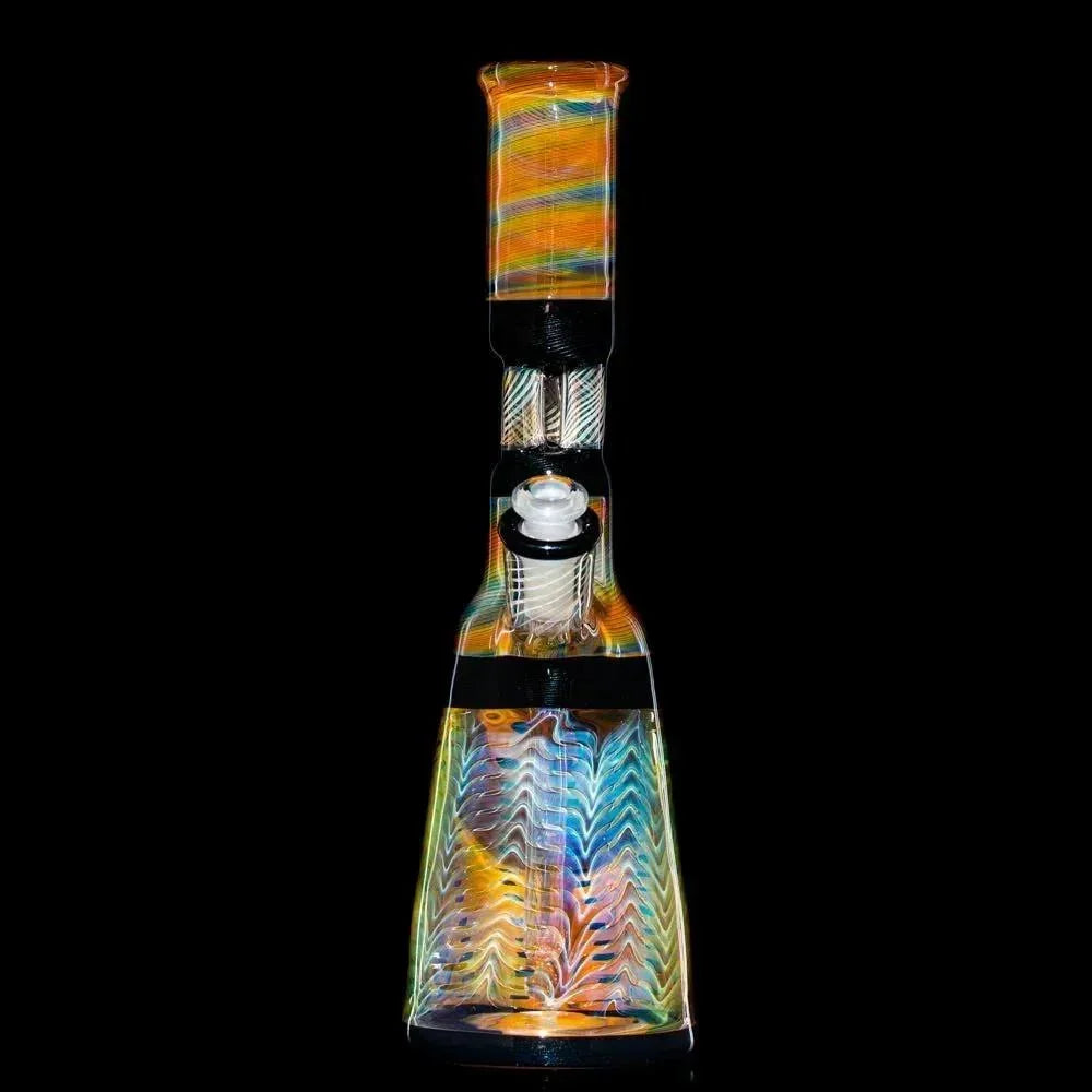 Colorful glass water pipe with triple pillar perc design against black background