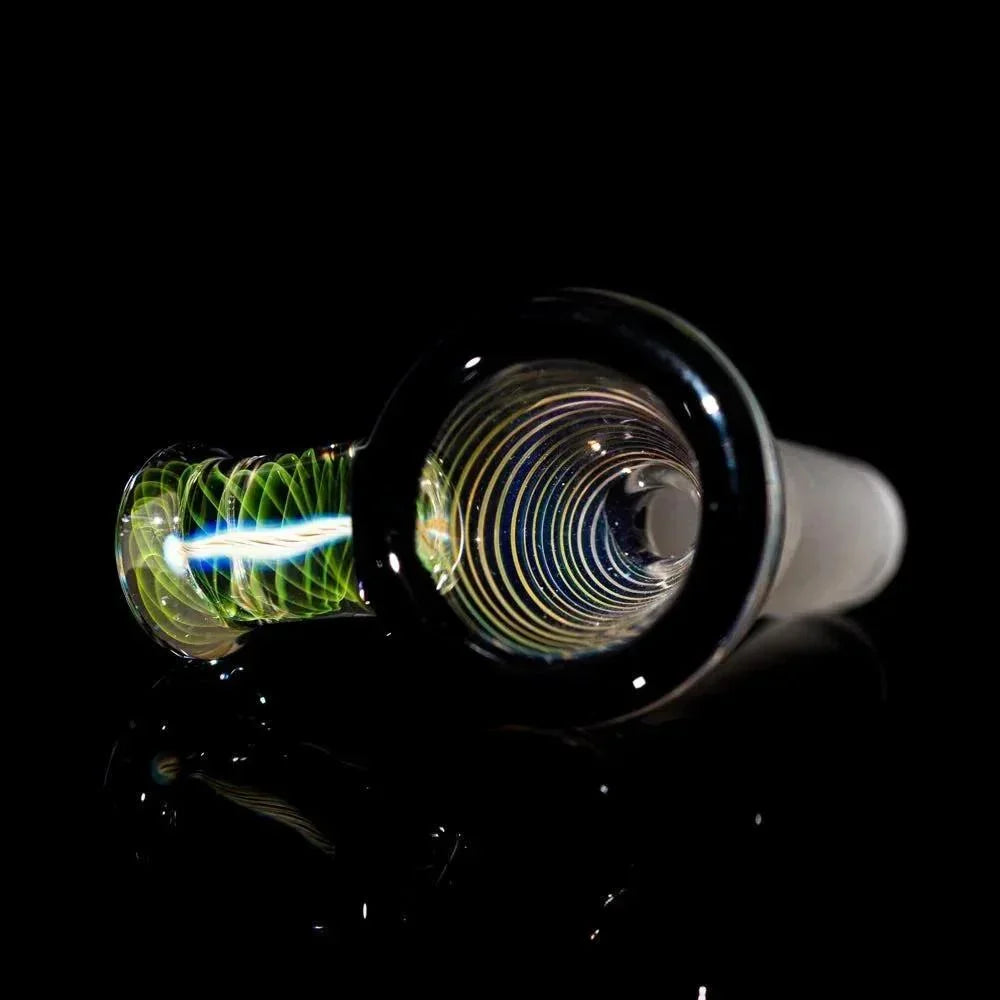Close-up of a colorful glass bong slide with spiral design on black background